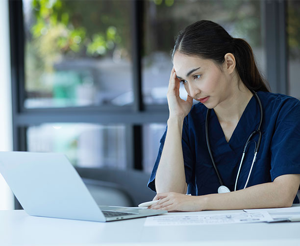 Worried Doctor Looking At Computer