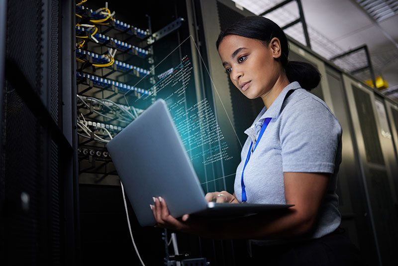 woman looking at computer checking an IT network