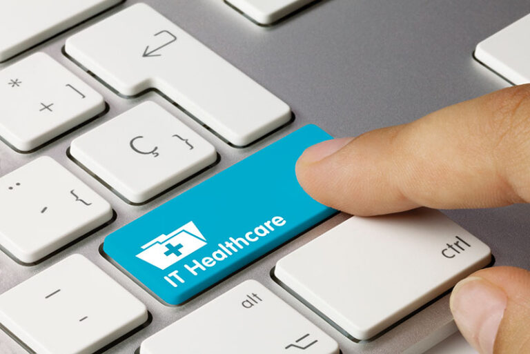 Finger pointed on keyboard with blue button that says “IT healthcare”