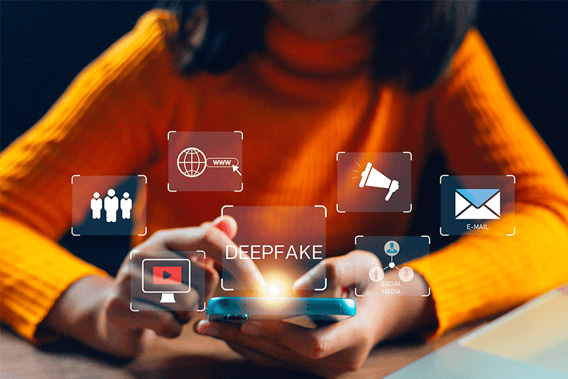 person on phone with the word deepfake above it surrounded by online media graphics
