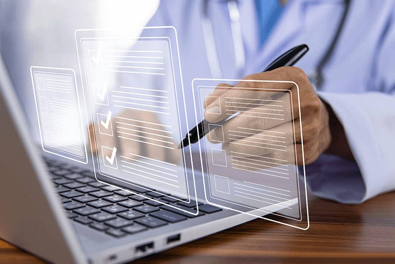 doctor checking off a digital checklist graphic in front of a laptop