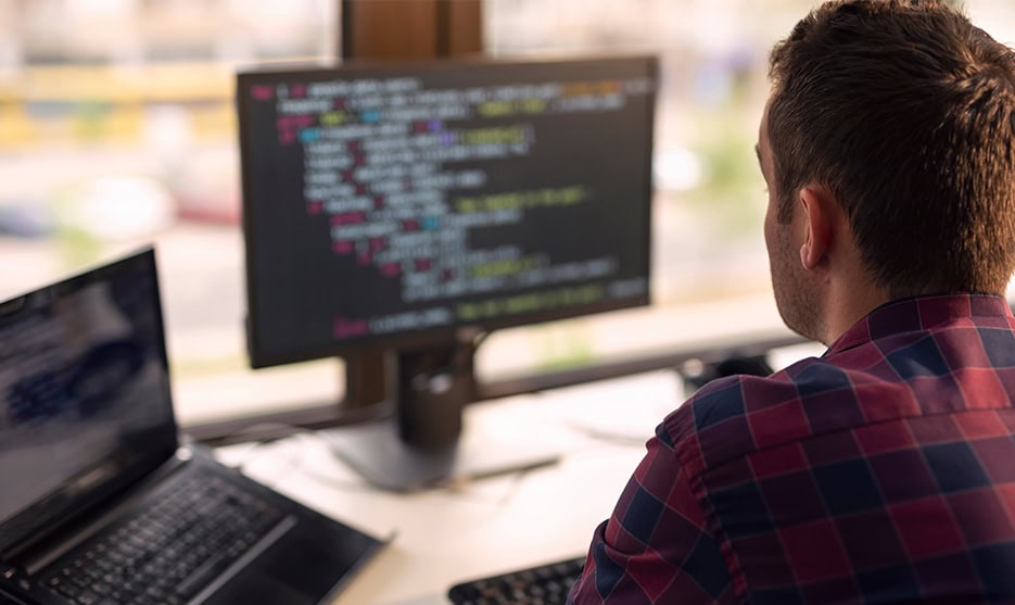Programmer Working On Code